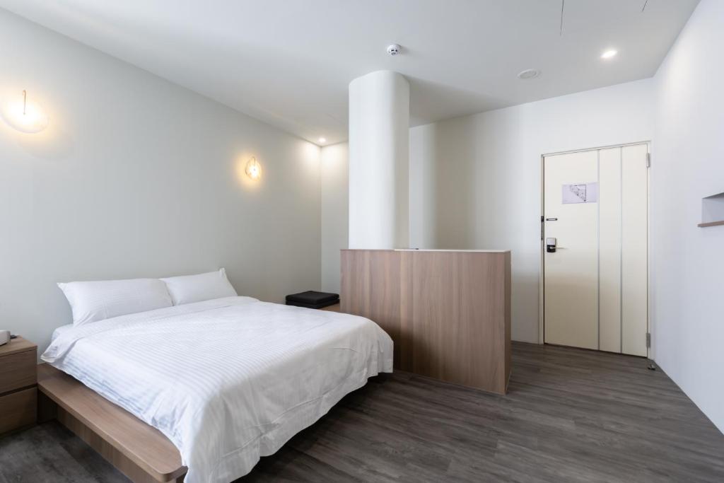 Postel nebo postele na pokoji v ubytování Yu Tainan BnB