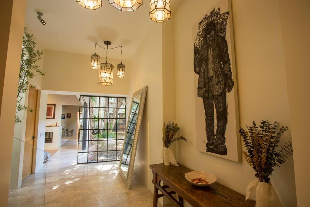 a hallway with a statue of a man on the wall at Jacaranda House in San Miguel de Allende