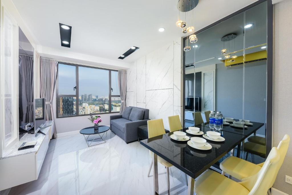 a living room with a dining table and a couch at Elysium CBD Rivergate Apartment - Gym & Pool - Free 4G sim for 3 nights in Ho Chi Minh City