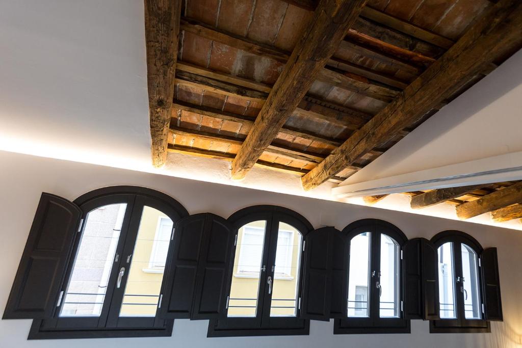 a row of windows in a building with wooden ceilings at L’Angorfa de Casa Santiago, casa rural in Tivenys
