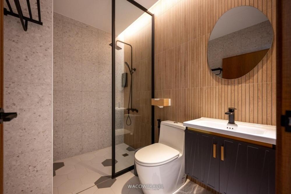 a bathroom with a toilet and a sink and a mirror at Misu in Xiaoliuqiu