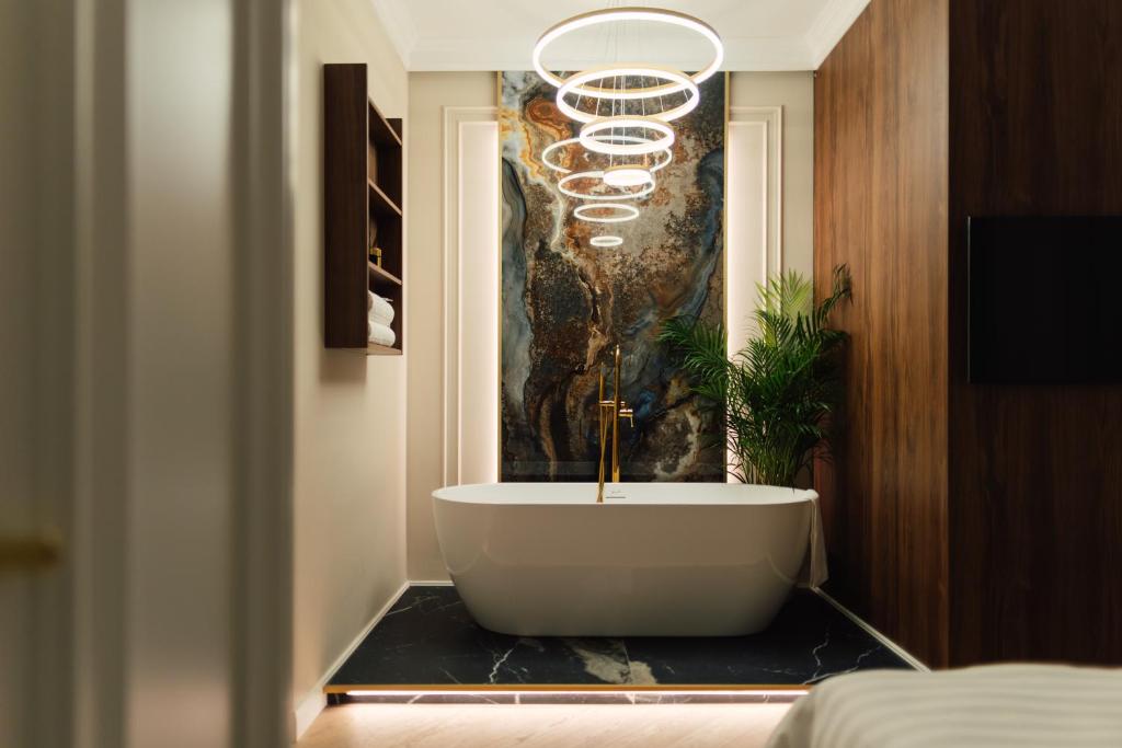 a bathroom with a bath tub on a table at Onix Residence in Baia Mare