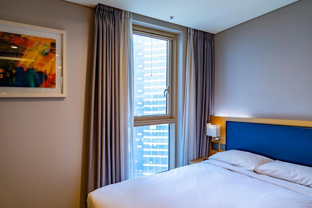 Postel nebo postele na pokoji v ubytování Centum Business Hotel