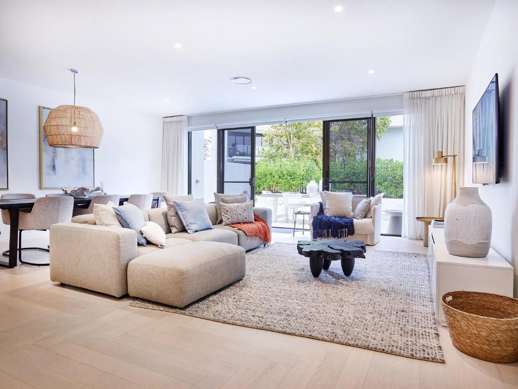 a living room with couches and a table at Palm Beach Lux Villa in Gold Coast