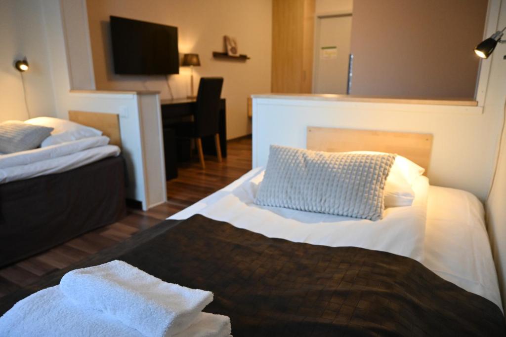 Postel nebo postele na pokoji v ubytování Hotell Lyktan