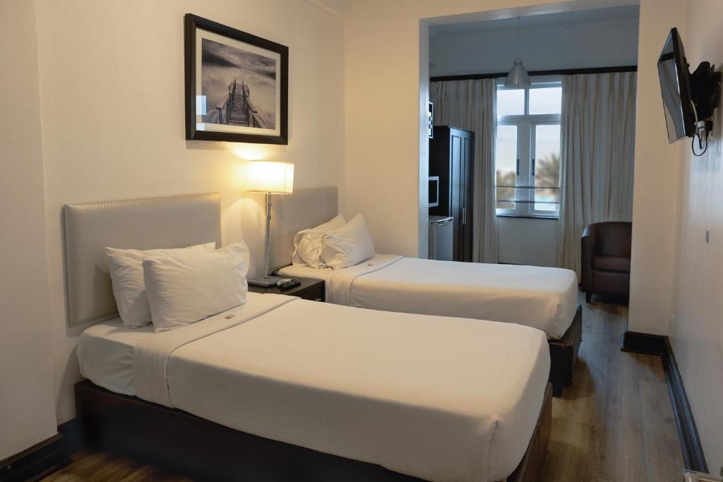Postel nebo postele na pokoji v ubytování Parade Hotel