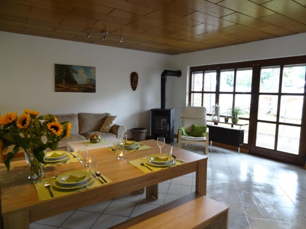 a living room with a table and a couch at Ferienhaus van Vliet in Morbach