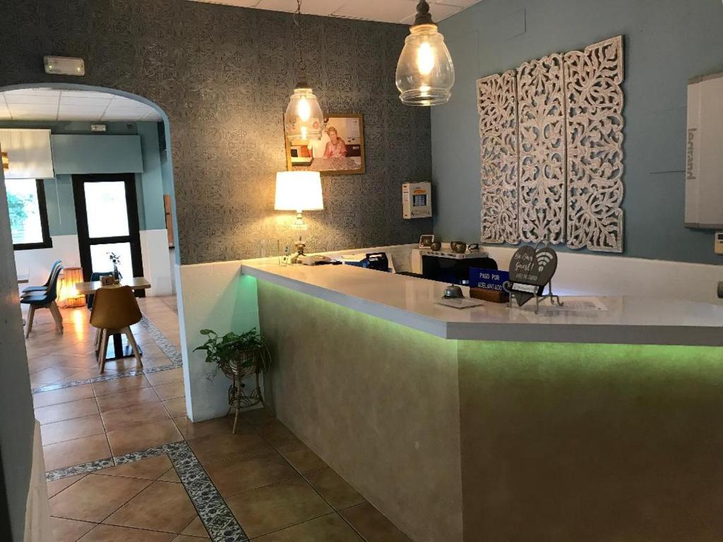a kitchen with a counter and a living room at Macavi in Rota