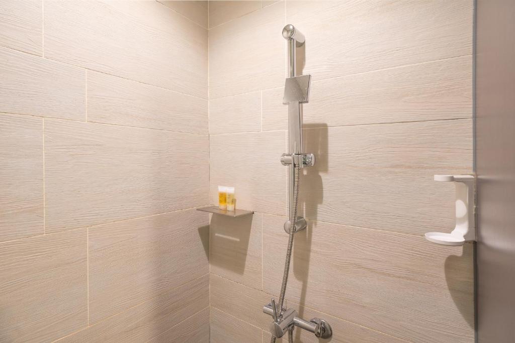 a shower with a glass door in a bathroom at CHECK inn Taipei Xinyi in Taipei