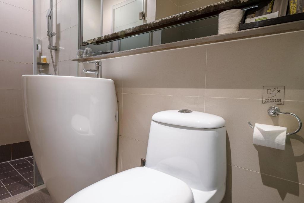 a bathroom with a white toilet in a room at CHECK inn Taipei Xinyi in Taipei