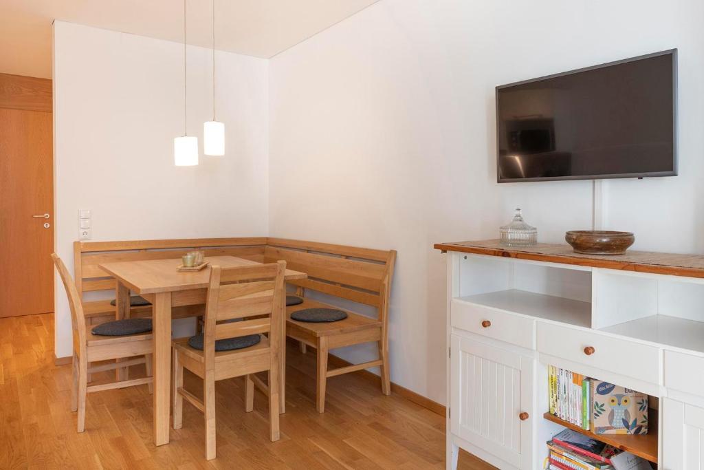 a dining room with a table and a tv at Ferienwohnung Spannring in Schruns-Tschagguns