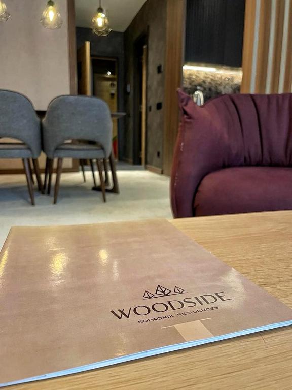 a box on a table in a room with a couch at Woodside RENT Kopaonik in Kopaonik