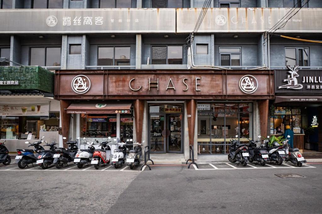 a group of motorcycles parked in front of a store at CHASE Hotel in Taichung