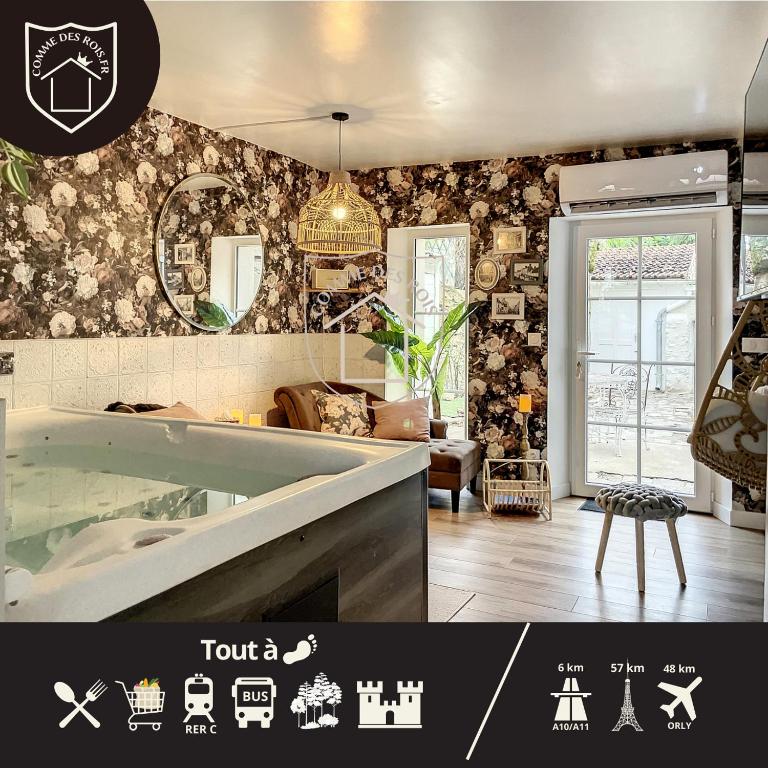 Elle comprend un salon et une salle de bains pourvue d'une baignoire. dans l'établissement La Romantique des Rois # Jacuzzi # Sauna, à Dourdan