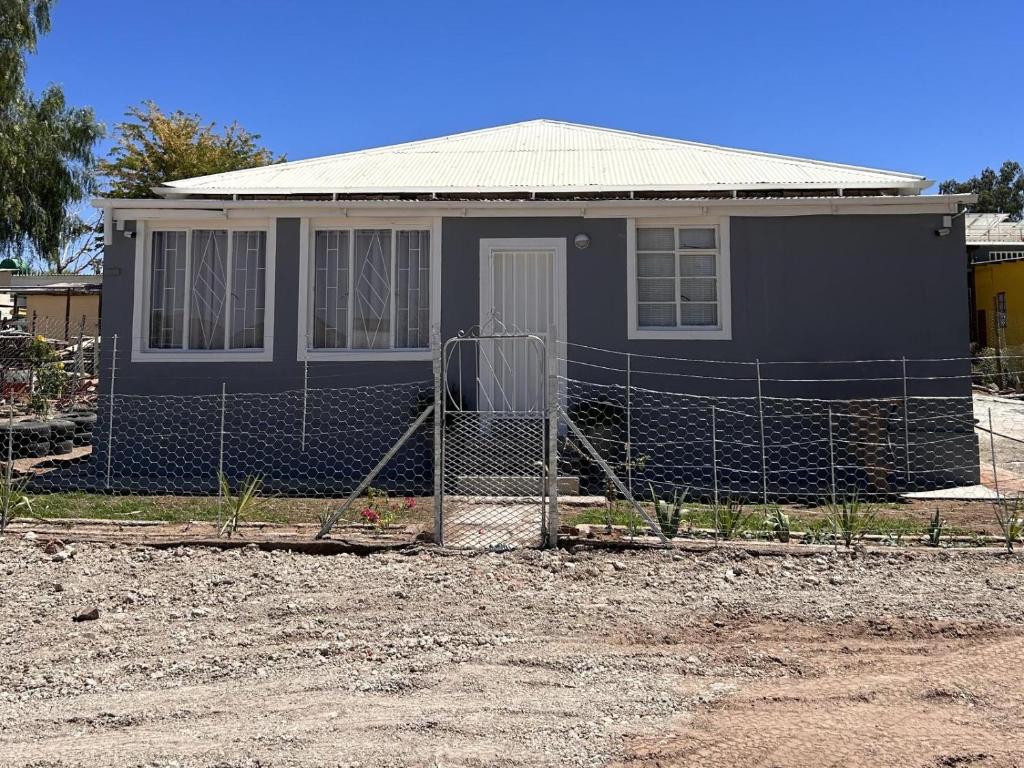 a house with a fence in front of it at Maltahöhe Self Catering in Maltahöhe