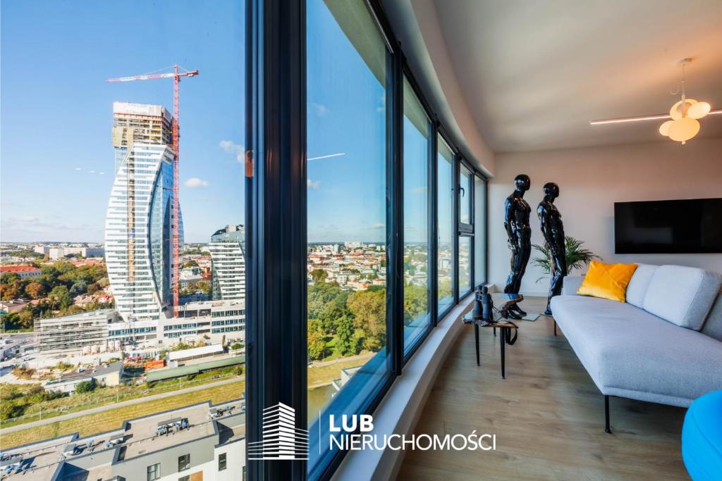 a living room with a view of a city at Panorama Capital Skyline - 17 piętro in Rzeszów
