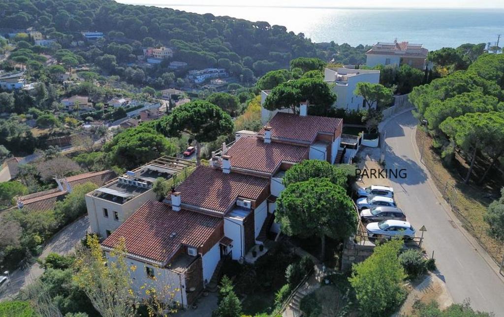 an aerial view of a house with a parking lot at Canyelles BBQ Apartment in Lloret de Mar