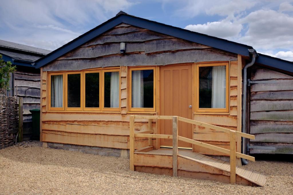 a cabin with a wooden door and a porch at The Chalet in Oxford