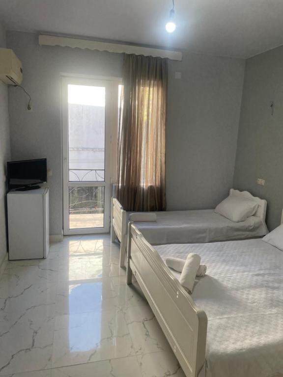 Postel nebo postele na pokoji v ubytování Amfitrita Hotel Ureki