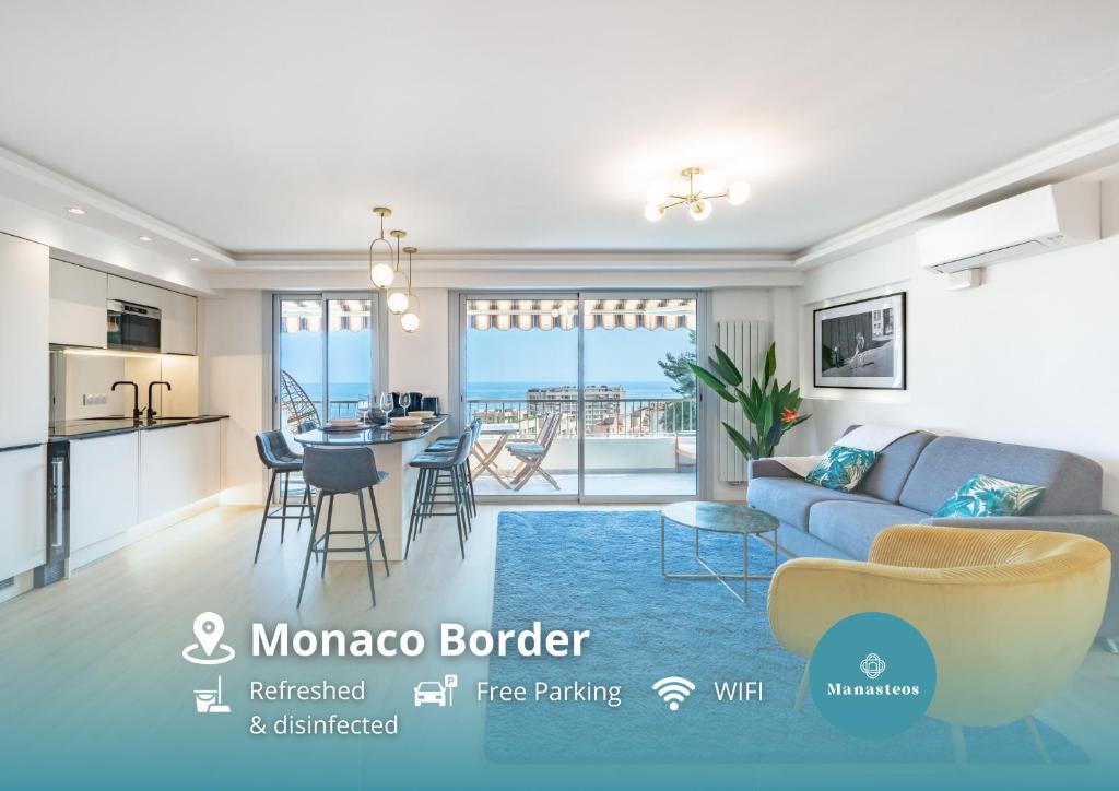 a living room with a blue couch and a kitchen at Baie de Monaco, Vue Mer, Terrasse, Parking Gratuit - AF in Beausoleil