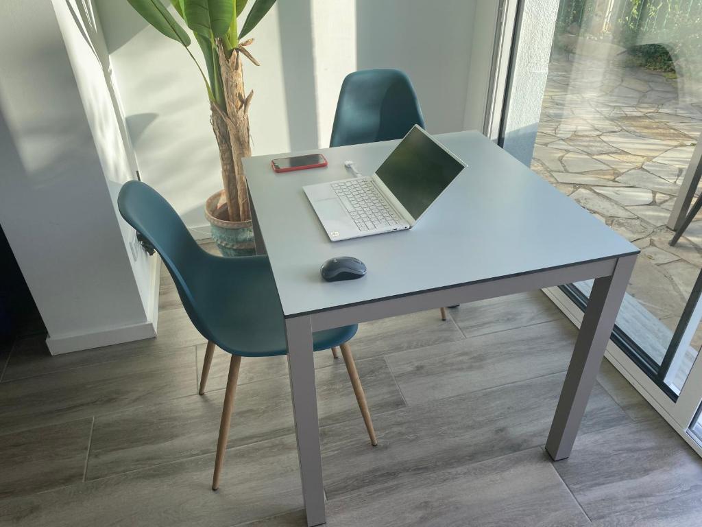 a desk with a laptop and a mouse on it at Canyelles BBQ Apartment in Lloret de Mar