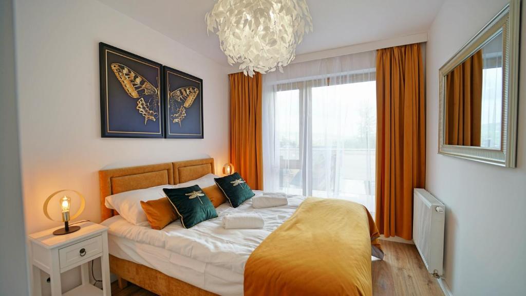 A bed or beds in a room at Apartamenty Every Sky Szklarska Poręba - Kilińskiego 17A-17B-17C