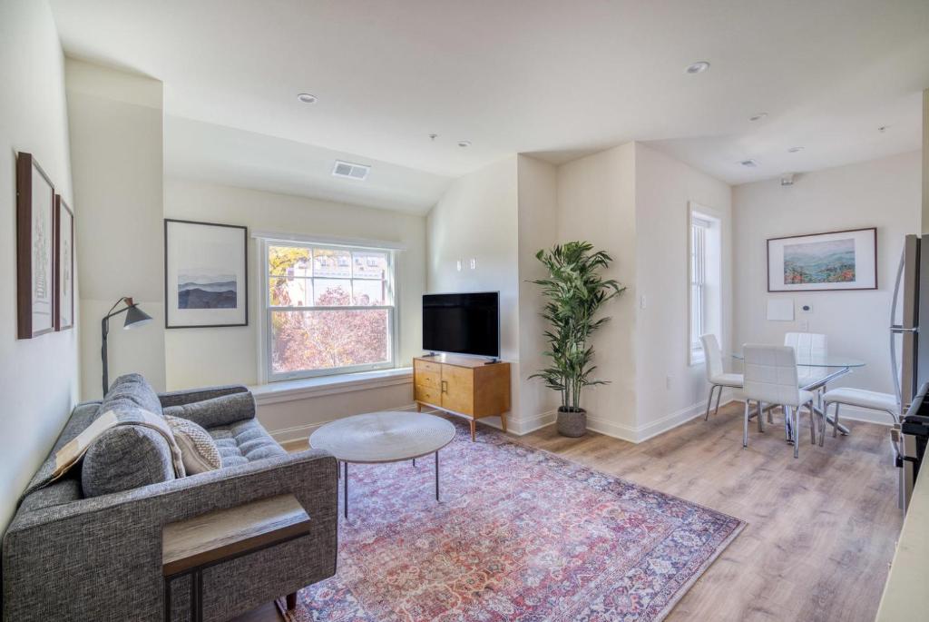 a living room with a couch and a tv at Dupont Circle 1br w wd nr bars metro station WDC-750 in Washington, D.C.