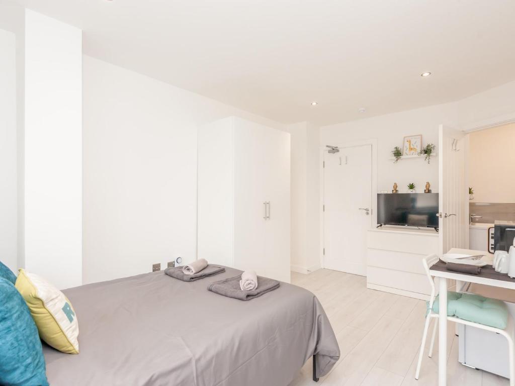a white bedroom with a bed and a desk at Pass the Keys Burnley Central Hub Couples Choice in Burnley