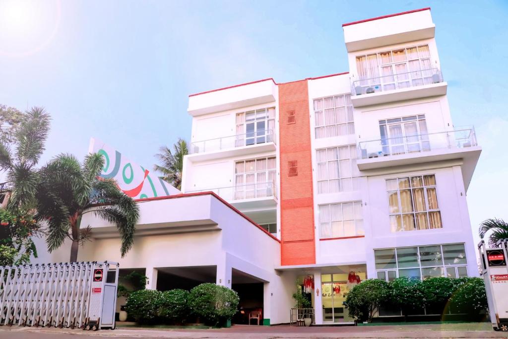 a building with a fence in front of it at Kanola Luxury Hotel in Anuradhapura