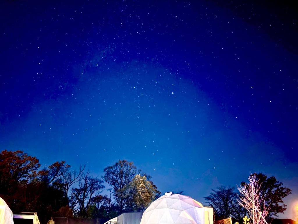 a starry night with domes in a field at chillout glamping zao in Zao
