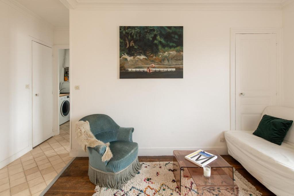 a living room with a couch and a chair at Voltaire Cosy appartement au centre de Paris in Paris