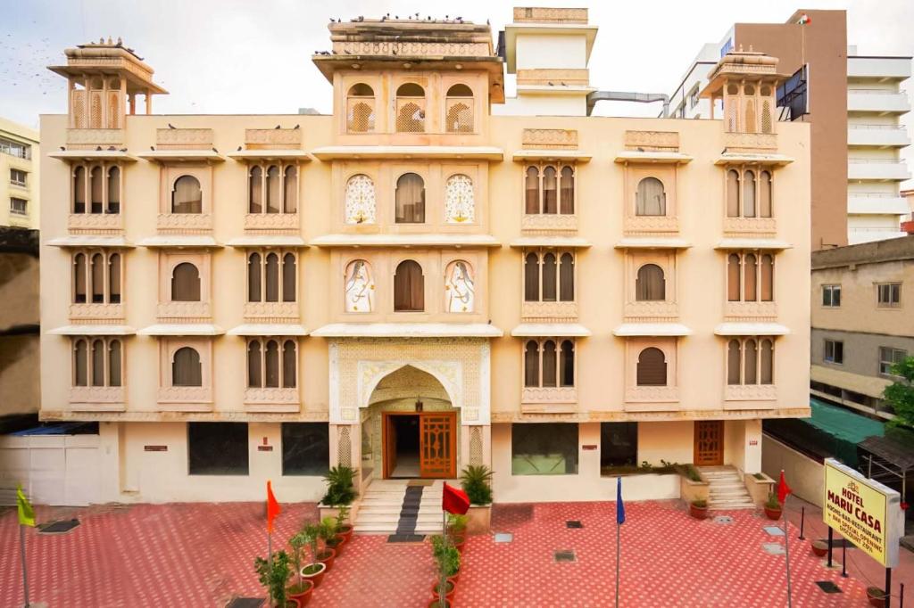 a building in the middle of a city at Hotel Maru Casa in Jaipur