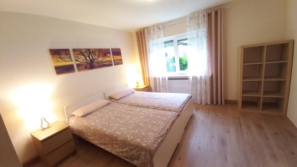 Holiday Apartment في Oberveischede: غرفة نوم صغيرة بها سرير ونافذة