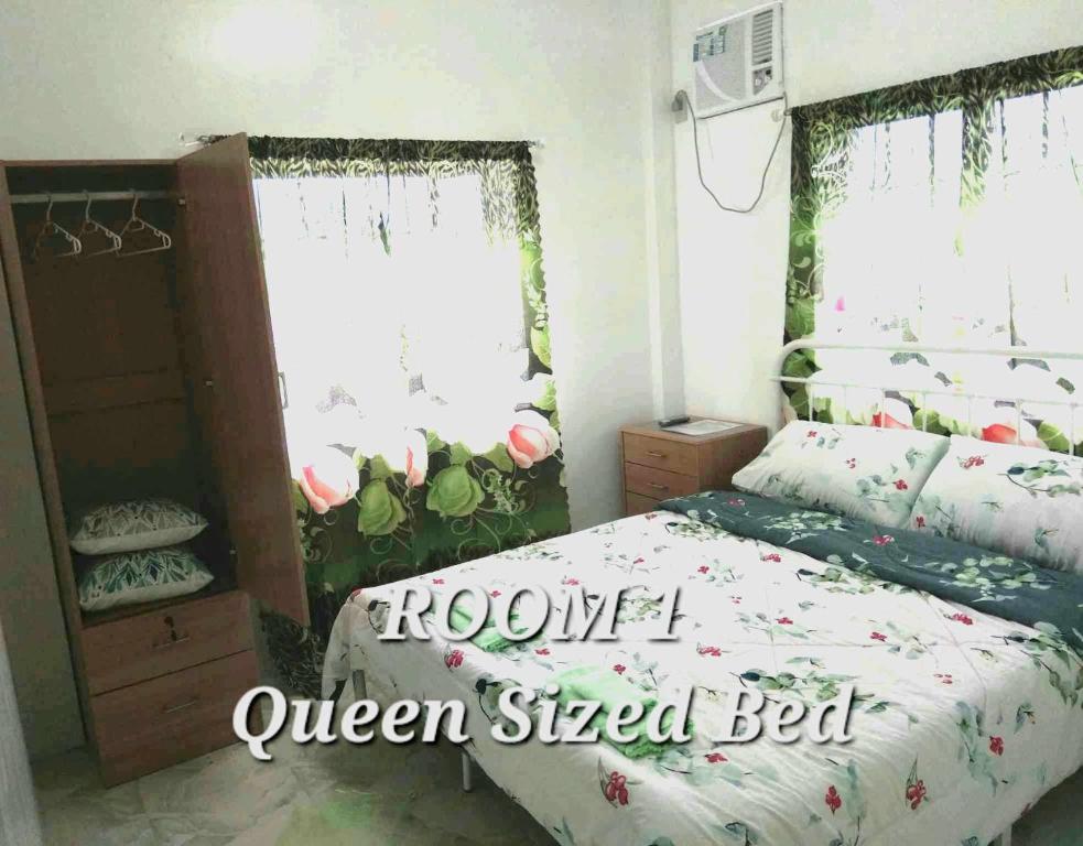 a bedroom with a bed and a window at DeiHouse in Samal