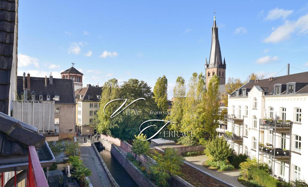 a view of a city with buildings and a church at Victoria Boardinghouse in Düsseldorf