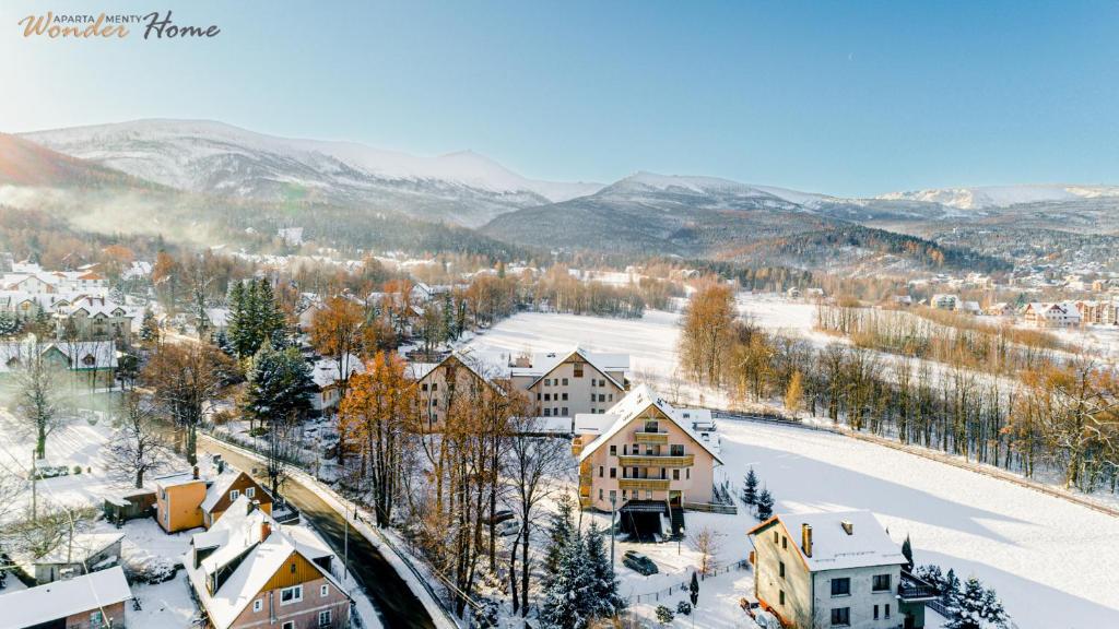 a town in the winter with snow on the ground at Wonder Home - Apartamenty w przyziemiu - cicha okolica in Karpacz
