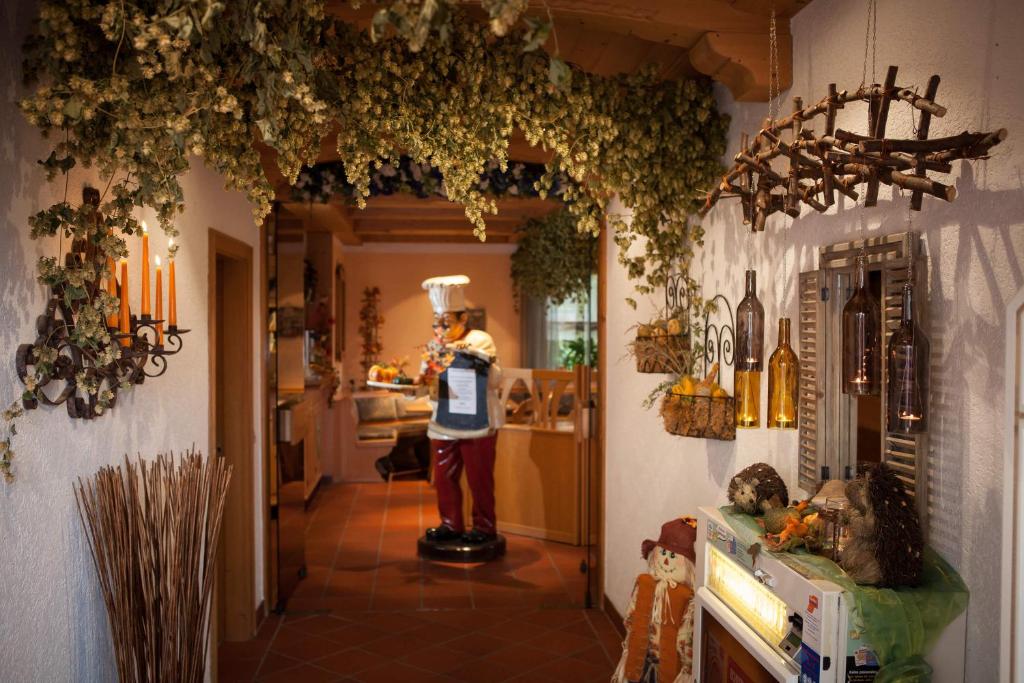 a person standing in a hallway with a kitchen at Landgasthof Linden in Linden