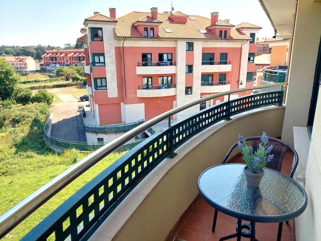 a balcony with a table and a view of a building at La Marina Posada de LLanes VUT-3648-AS in Posada de Llanes