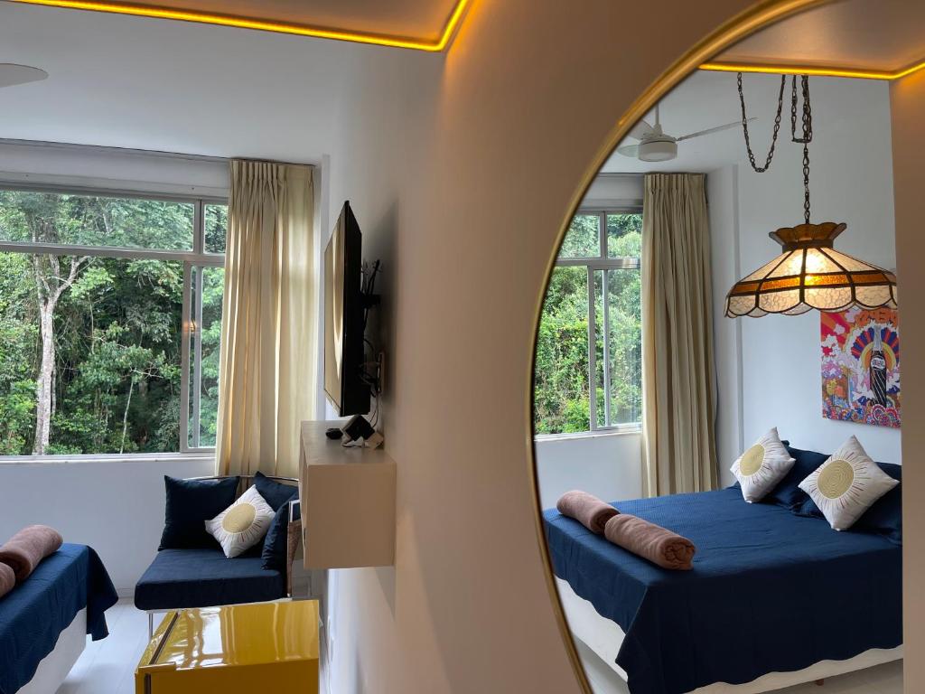a bedroom with two beds and a mirror at STUDIO12 in Petrópolis