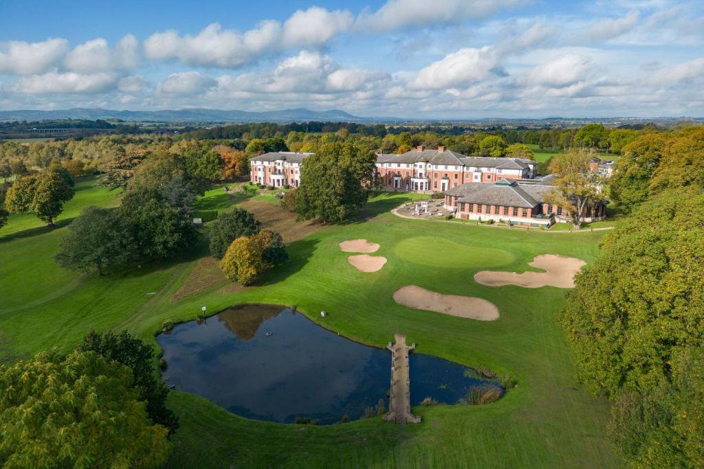 an aerial view of a mansion with a golf course at Hilton Puckrup Hall, Tewkesbury in Gloucester
