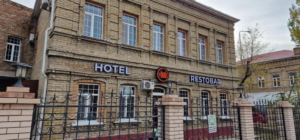 a hotel sign on the side of a brick building at The hub - Hotel & Restobar in Atyrau