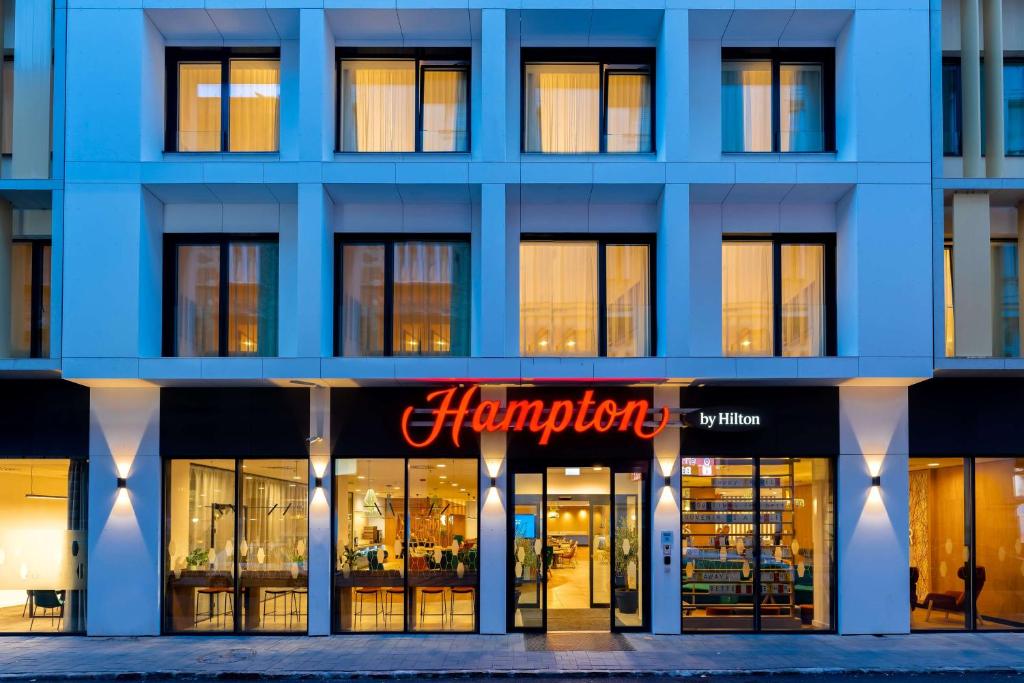 a large blue building with a pharmacy sign on it at Hampton By Hilton Budapest City Centre in Budapest