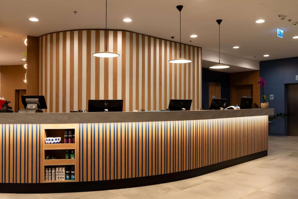 a bar in an office with a striped wall at Hampton By Hilton Budapest City Centre in Budapest