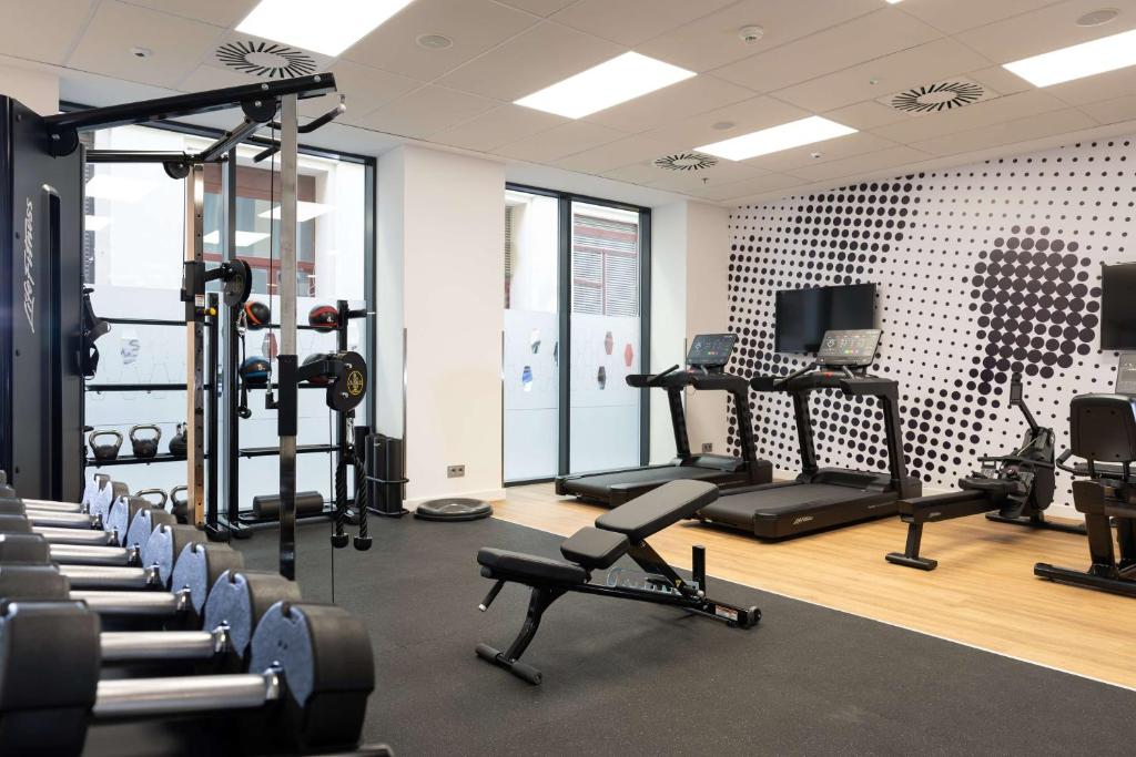 a gym with several treadmills and exercise bikes at Hampton By Hilton Budapest City Centre in Budapest
