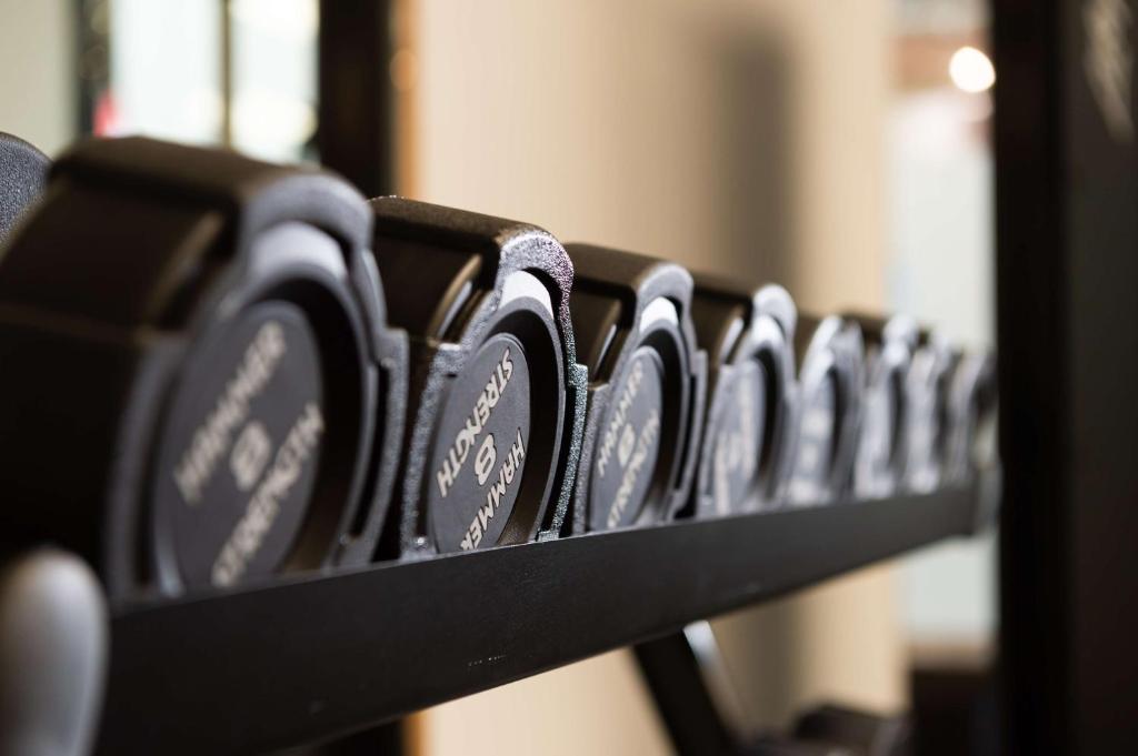 a row of black benches in a room at Hampton By Hilton Budapest City Centre in Budapest