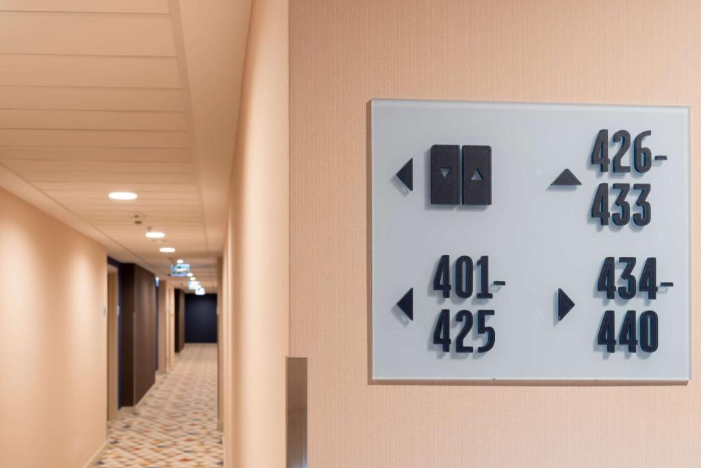 a clock on the wall of a hallway at Hampton By Hilton Budapest City Centre in Budapest