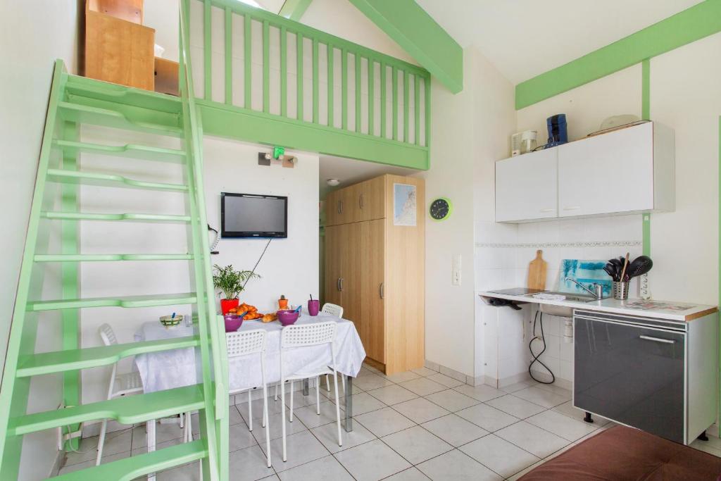 a kitchen with a green ladder and a table at Bidart - balcon - Proche plage in Bidart