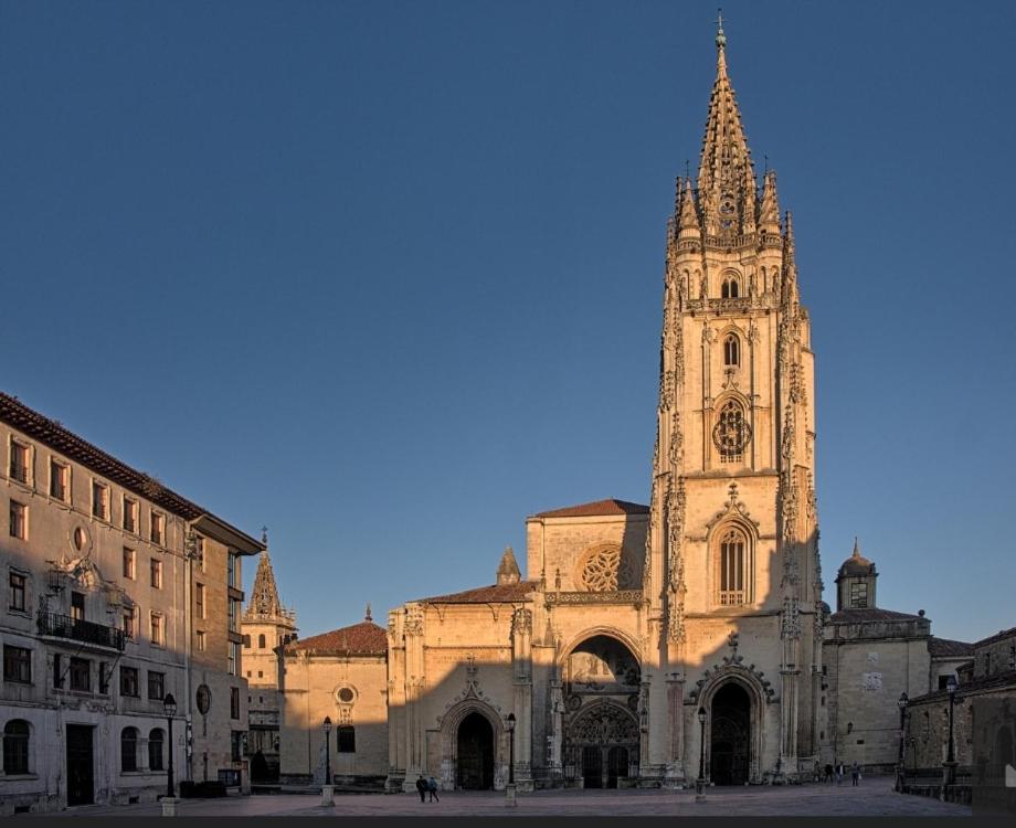 a church with a tower with a clock on it at Alojamiento Oviedo 1 in Oviedo