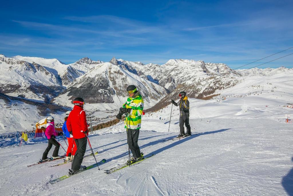 a group of people standing on a snow covered mountain at Chalet San Valentino - Happy Rentals in Livigno