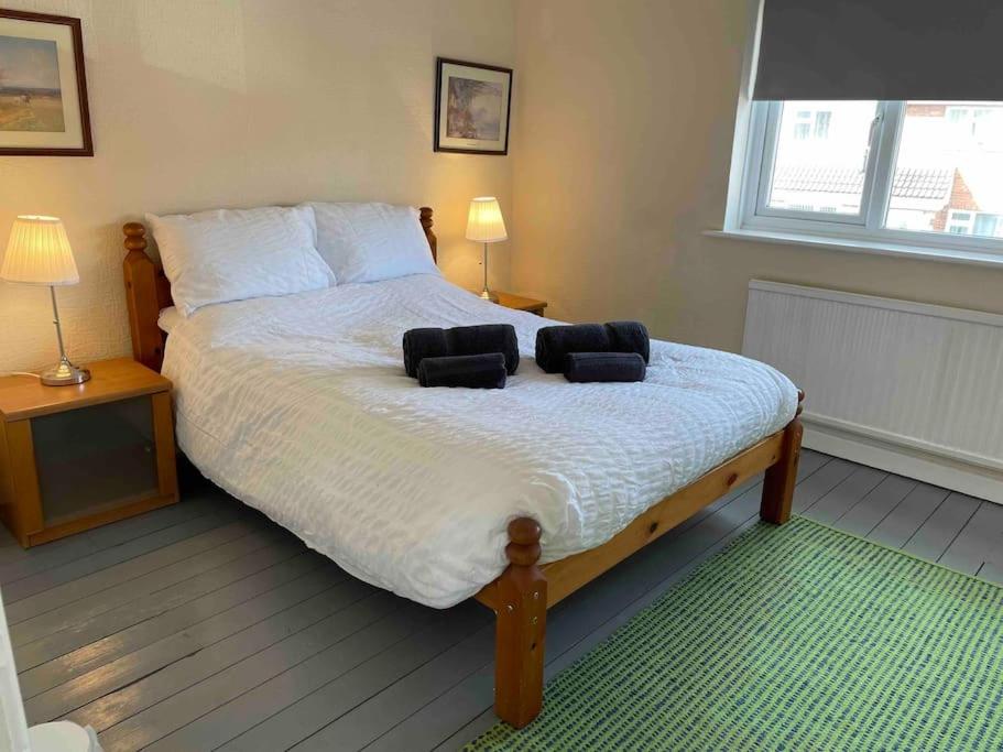 a bedroom with a large bed with two pillows on it at 2 Bed House Oxford in Oxford